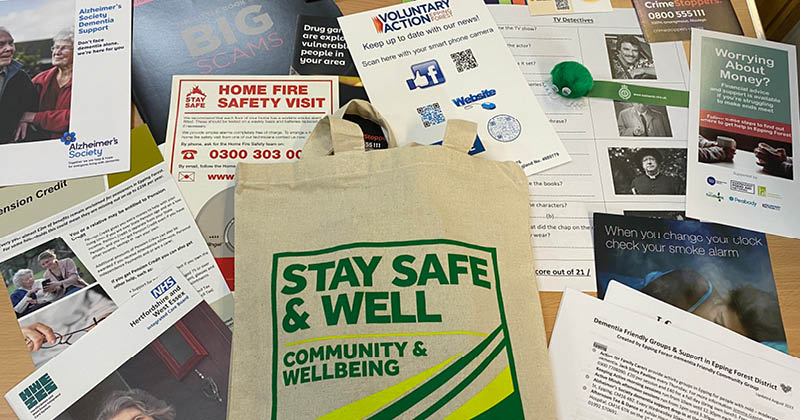 Stay safe and well bag with leaflets behind it