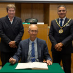 Cllr Les Burrows signs to be Chairman for 2024-2025, with EFDC CEO Georgina Blakemore and Chairman Darshan Sunger